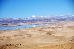 35 Sand Dunes Morning Between Old Zhongba And Paryang Tibet The mountains are reflected in the water next to the sand dunes in the morning sun on the road between Old Zhongba and Paryang Tibet.